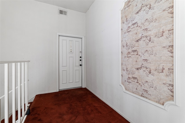 hallway with dark colored carpet