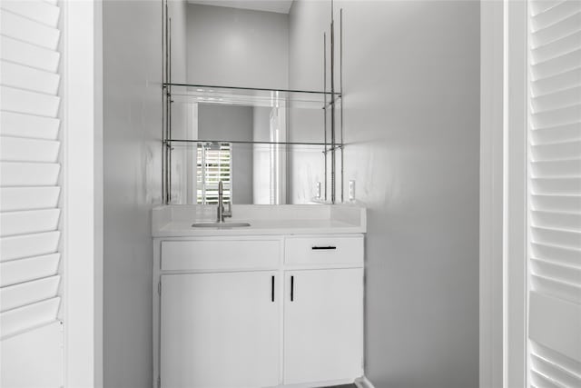 bar featuring sink and white cabinets