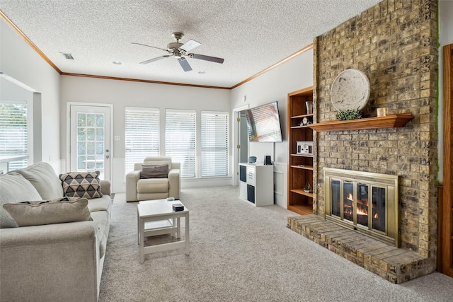 carpeted living room featuring crown molding, a textured ceiling, a fireplace, and ceiling fan