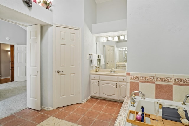 bathroom featuring a bath, tile walls, tile patterned flooring, and vanity