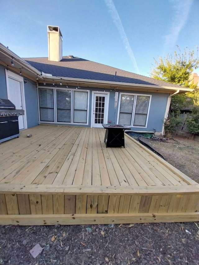 wooden terrace with a grill