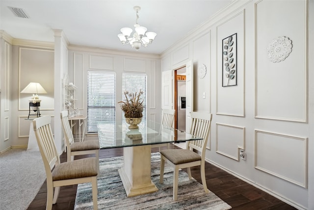 dining space featuring a notable chandelier, dark wood-type flooring, and crown molding