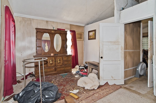 interior space with ornamental molding, lofted ceiling, wood walls, and carpet flooring