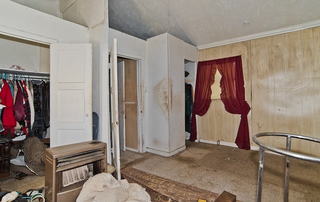 carpeted bedroom with a closet and crown molding