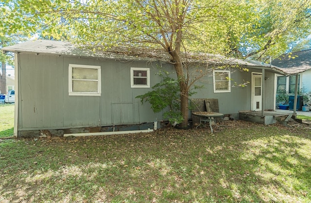 view of side of property with a yard