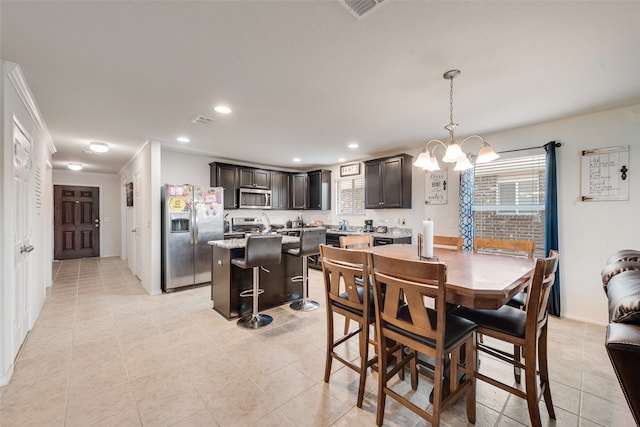 tiled dining room featuring an inviting chandelier and crown molding