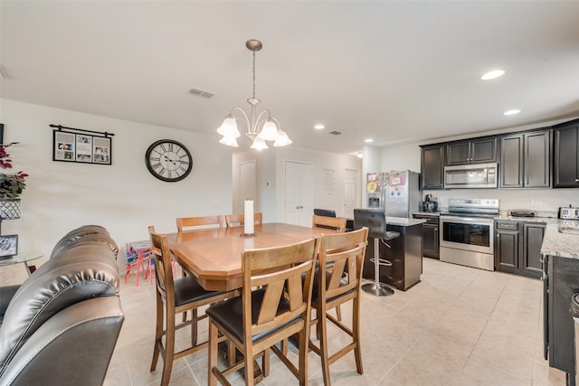 tiled dining room with an inviting chandelier