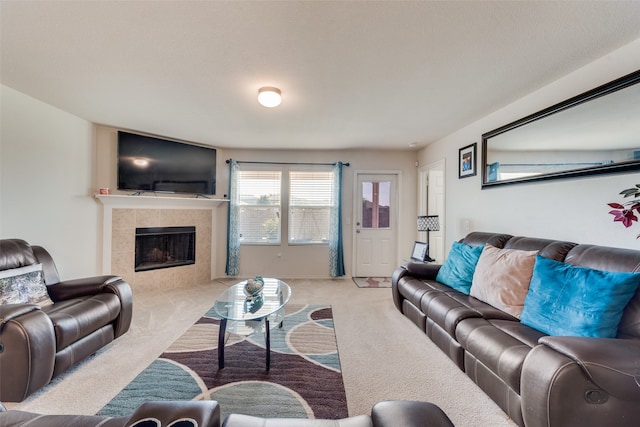 carpeted living room featuring a tile fireplace