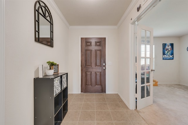 carpeted foyer entrance with french doors and crown molding