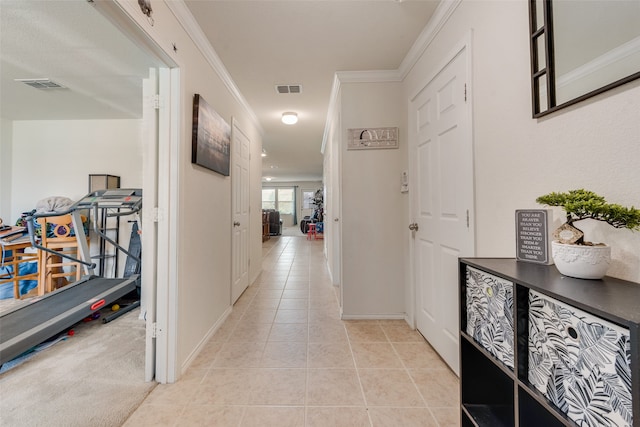 corridor with ornamental molding and light tile patterned floors