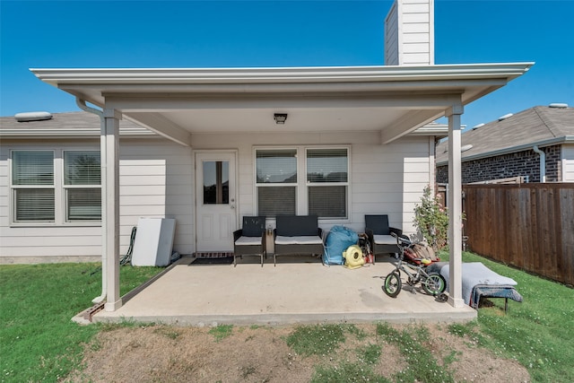 back of property with a patio area and a yard