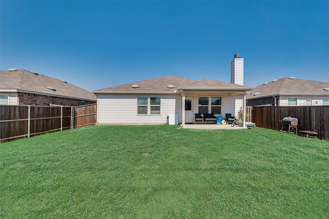 back of house with a yard and a patio area