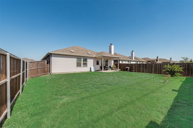 back of property featuring a yard and a patio area