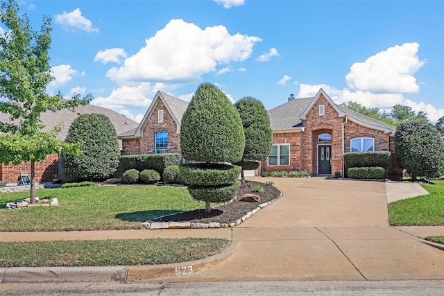 tudor home featuring a front lawn