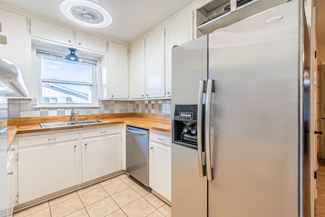 kitchen with white cabinetry, appliances with stainless steel finishes, sink, and wood counters