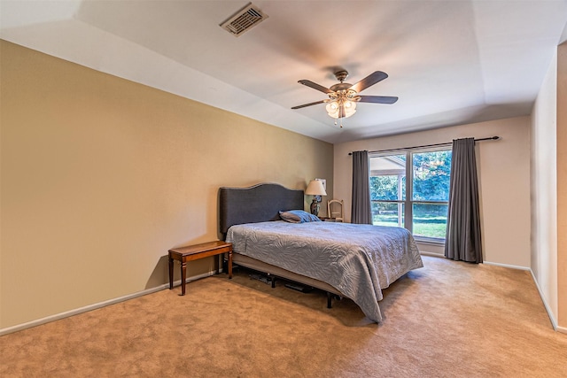 bedroom featuring light carpet, baseboards, visible vents, and a ceiling fan