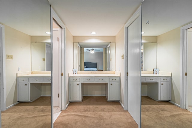 full bath with carpet, vanity, baseboards, and ensuite bathroom