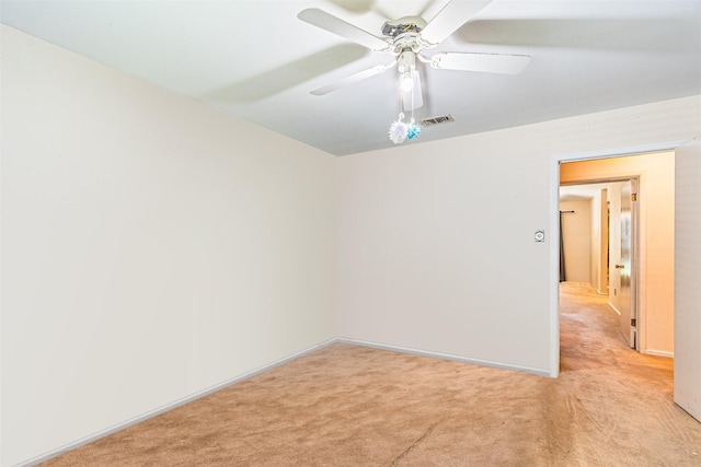 empty room with light carpet, visible vents, and a ceiling fan