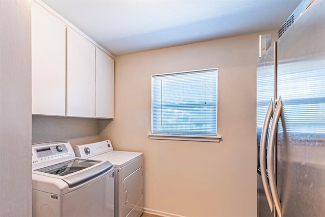 laundry room featuring cabinet space and washer and clothes dryer