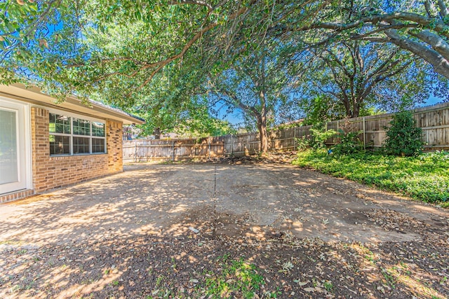 view of yard featuring a patio and a fenced backyard