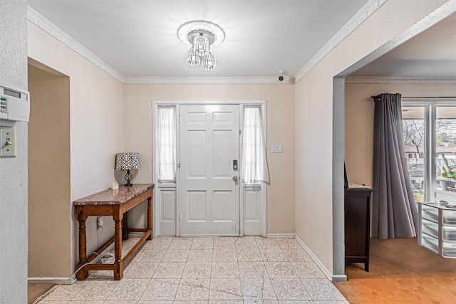 foyer featuring crown molding and baseboards