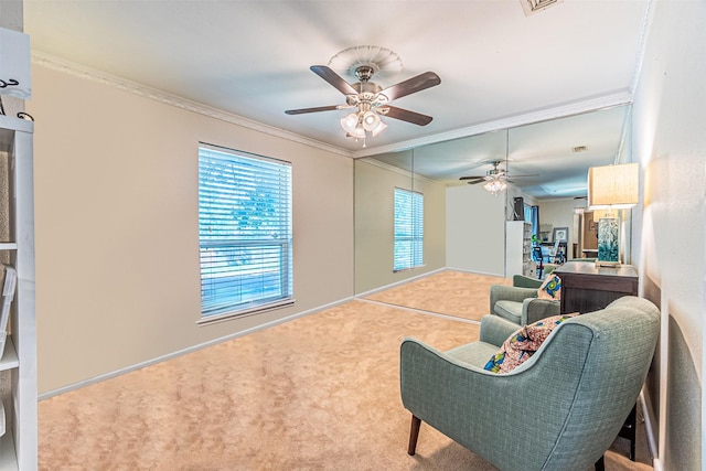 carpeted living room featuring crown molding and ceiling fan