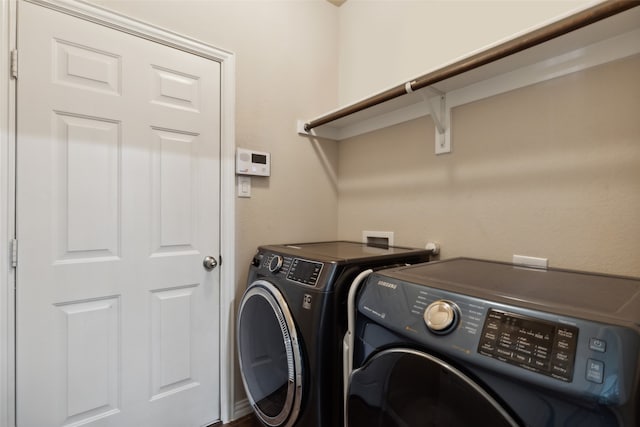 clothes washing area with separate washer and dryer