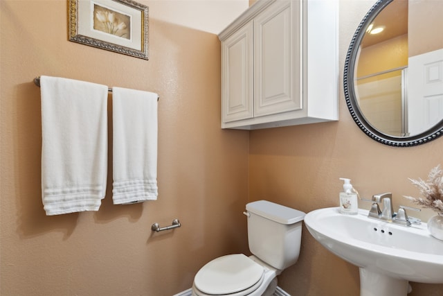 bathroom featuring sink and toilet