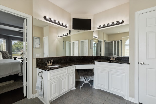 bathroom featuring vanity, tile patterned flooring, and a shower with door