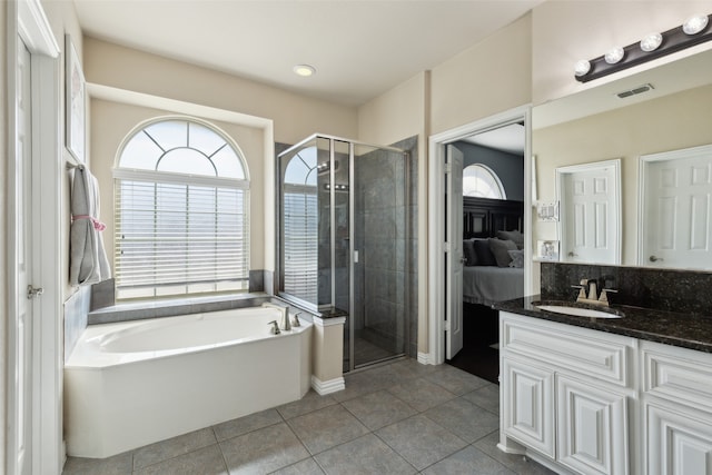 bathroom featuring tile patterned flooring, separate shower and tub, and vanity