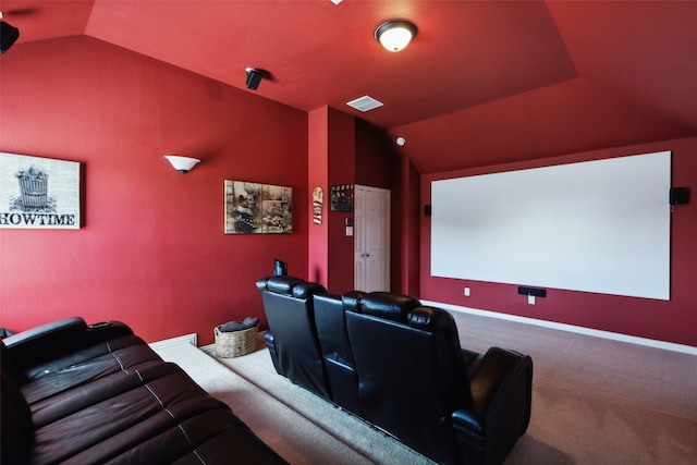 carpeted cinema with lofted ceiling