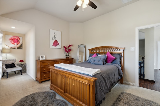 bedroom with light carpet, ceiling fan, and vaulted ceiling