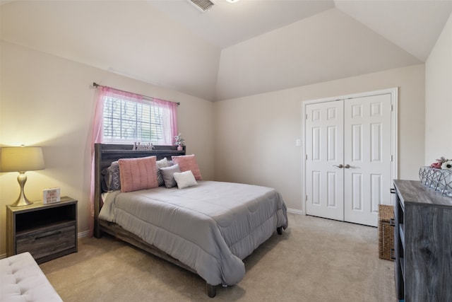 carpeted bedroom featuring lofted ceiling and a closet