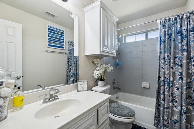 full bathroom featuring shower / tub combo, vanity, and toilet