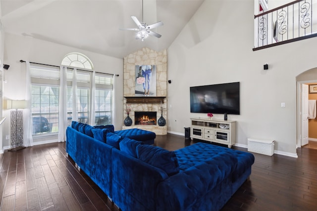 living room with dark wood-type flooring, high vaulted ceiling, a fireplace, and ceiling fan