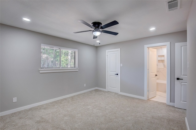 unfurnished bedroom with ensuite bath, ceiling fan, a closet, and light carpet