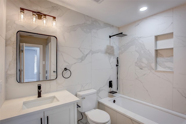 full bathroom featuring toilet, vanity, tile walls, and tiled shower / bath