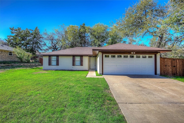 ranch-style home featuring a garage and a front lawn