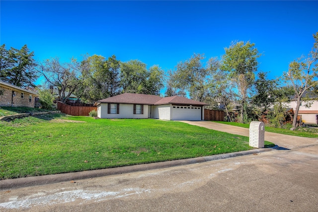 ranch-style house featuring a front yard and a garage