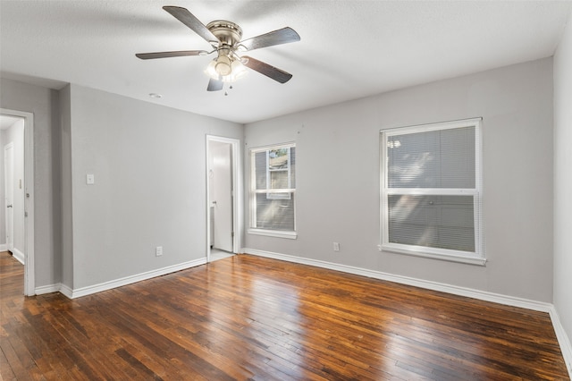 unfurnished room with ceiling fan, a textured ceiling, and dark hardwood / wood-style flooring