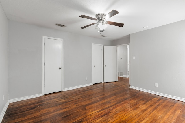 unfurnished bedroom featuring ceiling fan and dark hardwood / wood-style floors