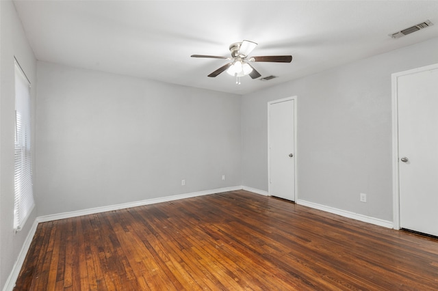 unfurnished room with ceiling fan and dark wood-type flooring