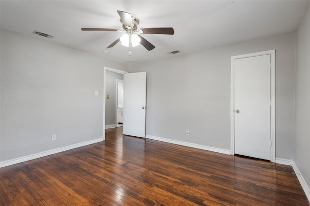 spare room with ceiling fan and dark wood-type flooring