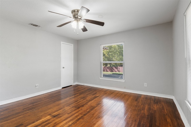 spare room featuring ceiling fan and dark wood-type flooring