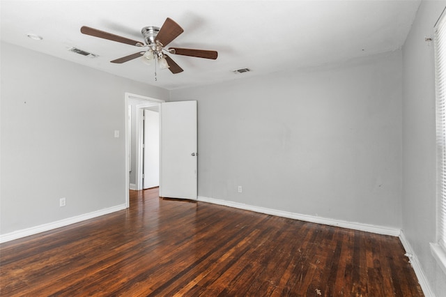 empty room featuring ceiling fan and dark hardwood / wood-style flooring