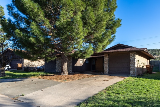 view of front of home with a garage and a front yard