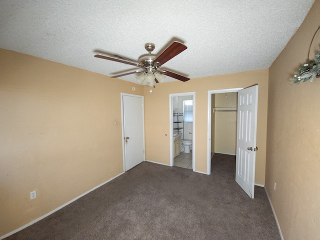 unfurnished bedroom with a closet, ensuite bath, ceiling fan, and light colored carpet