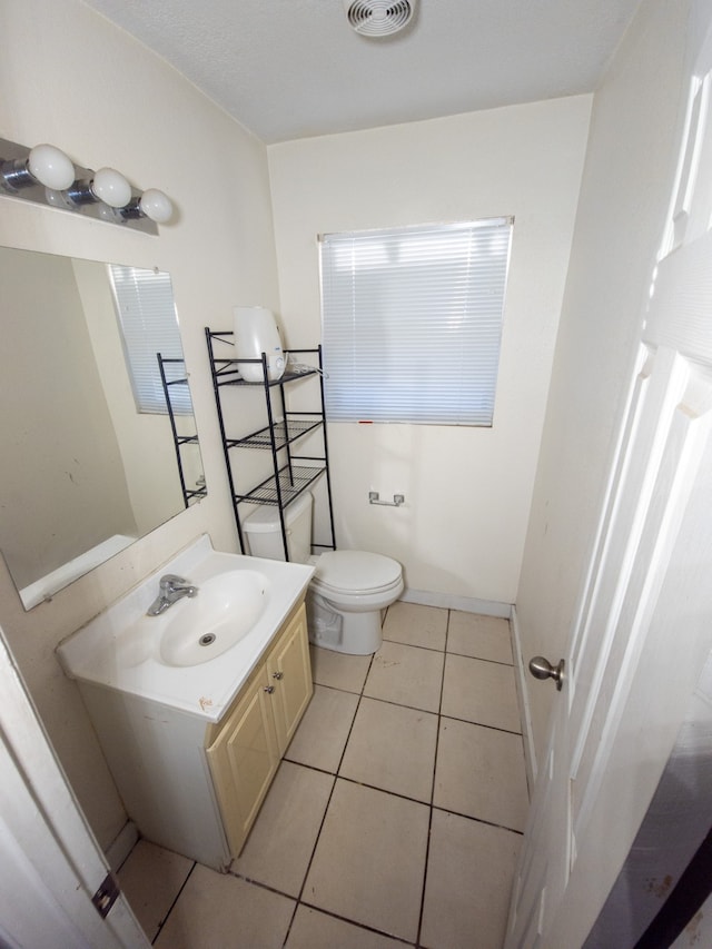 bathroom featuring tile patterned flooring, vanity, and toilet