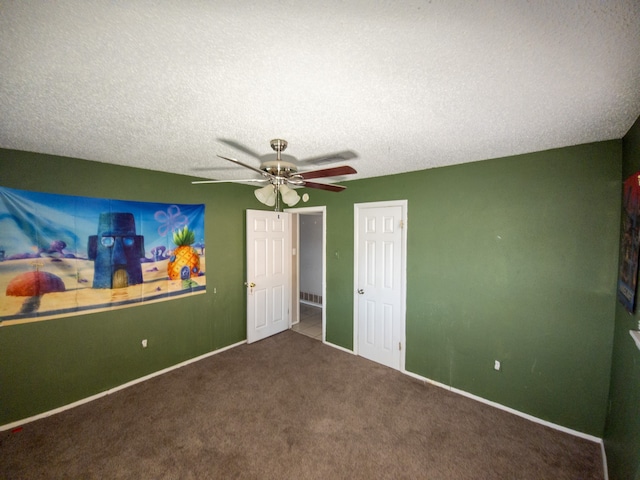 unfurnished bedroom with ceiling fan, carpet floors, and a textured ceiling