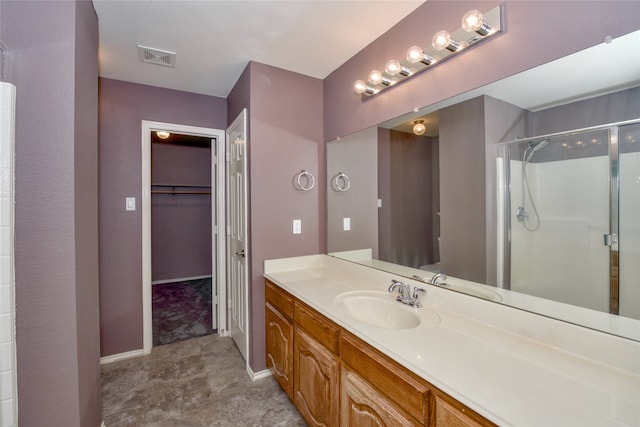 bathroom featuring walk in shower and vanity